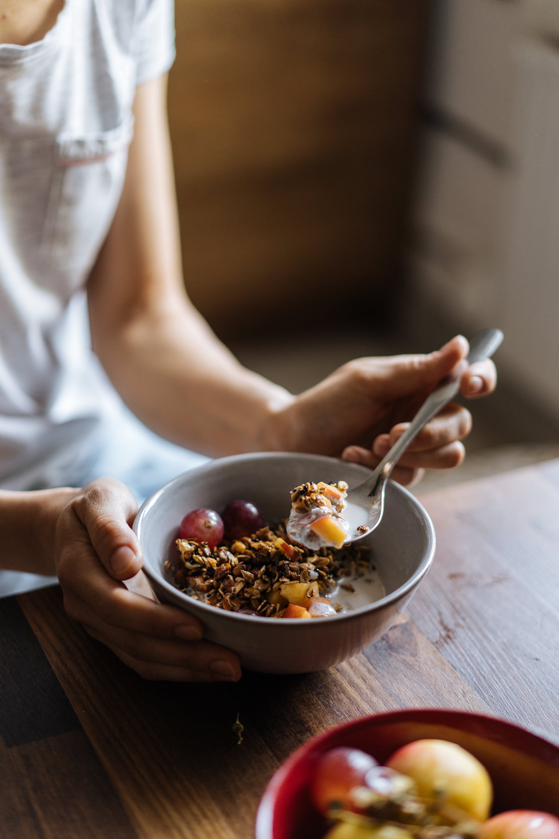 Woman eating oatmeal in the kitchen 